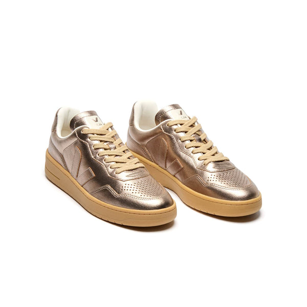 Three-quarter view of eco-friendly VEJA V-90 O.T. Leather shiny bronze and natural sneakers for women
