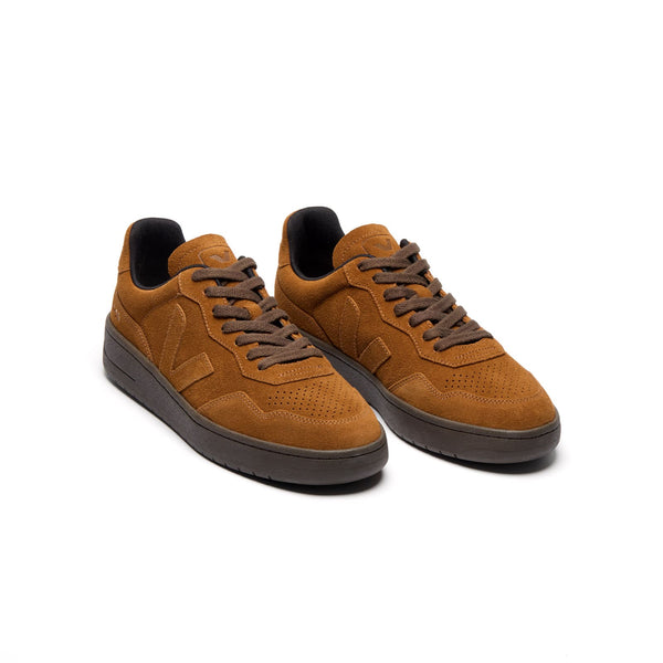 3/4 view of eco-friendly VEJA V-90 suede sneakers in cognac shades for men